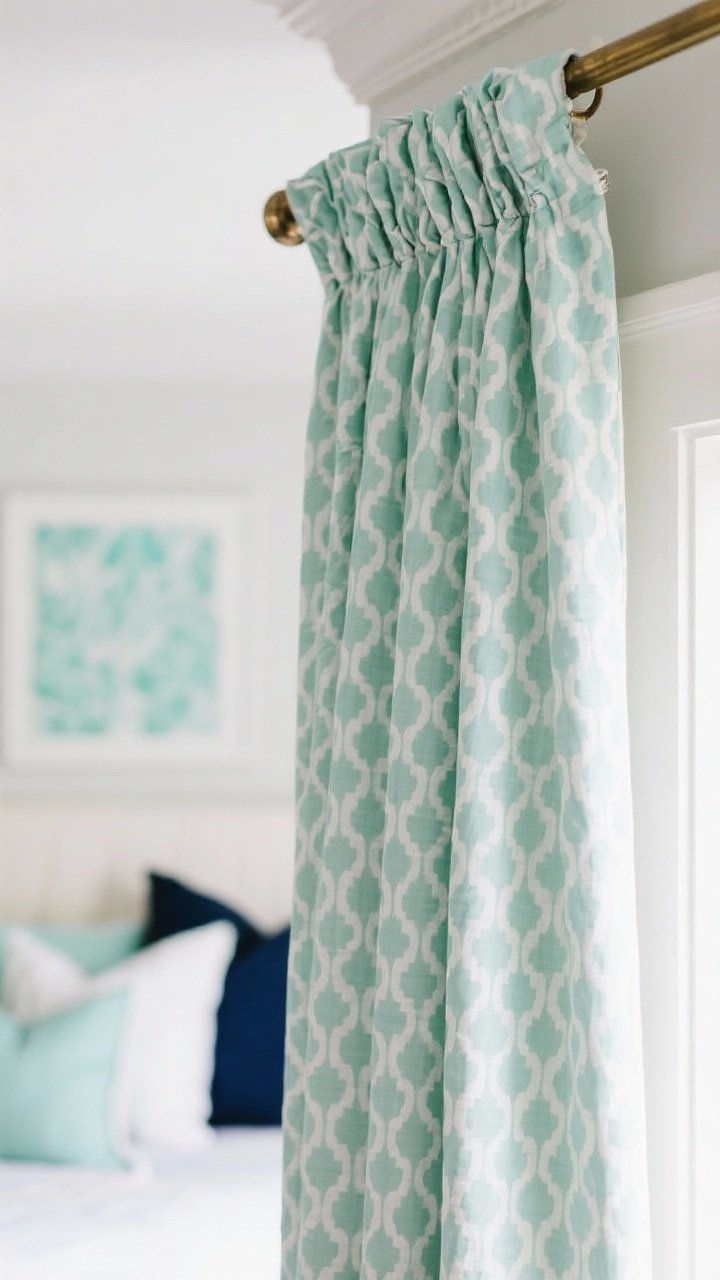 Closeup/detail shot: Mint patterned curtains with a subtle small-scale geometric repeat, lined with privacy lining so the pattern reads true from outside. Shot focuses on the Euro pleat header and a French return rod that curves to the wall to block side light. In the blurred background, coordinated pillows and art echo mint, white, and a navy accent. Photorealistic, playful yet refined.