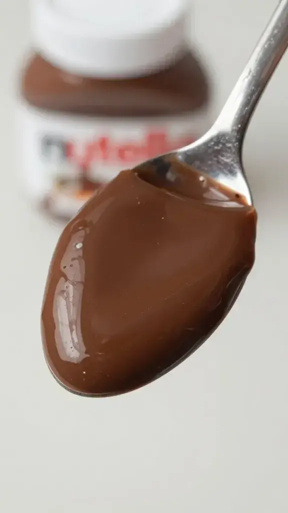 overhead shot of spoonful of glossy Nutella